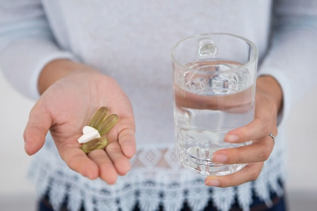 Multivitamins tablet taken in hands